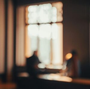 Abstract photo with warm tones showing silhouettes by a window in İstanbul.